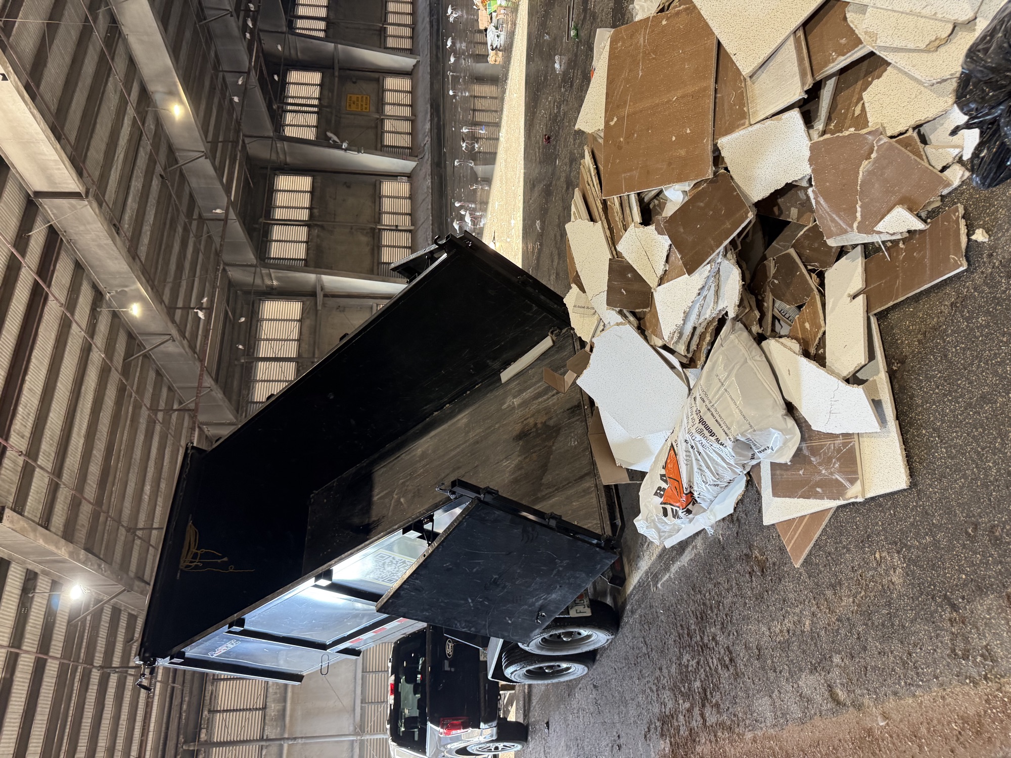 Safe USA Transport dump trailer tipping a load of drywall debris at a transfer station