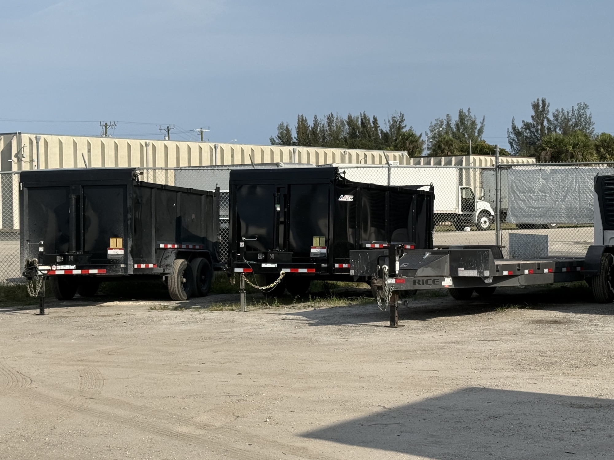 Row of black Safe USA Transport dump trailers at the West Palm Beach yard